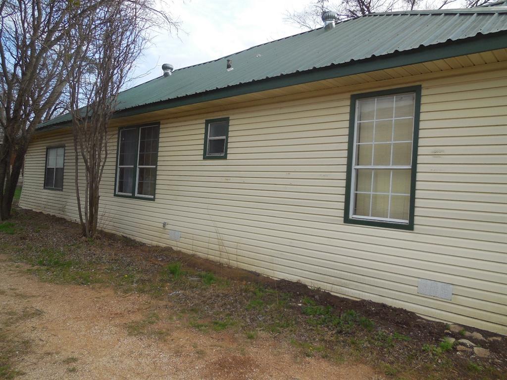 910 Sinclair Street Ranger, TX 76470 - Photo 2 of 21 a view of a house with a small yard