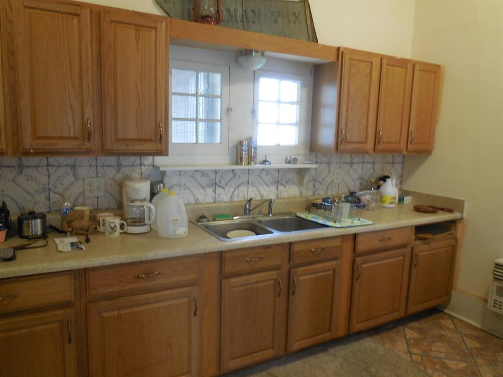 910 Sinclair Street Ranger, TX 76470 - Photo 7 of 21 a kitchen with a sink and cabinets