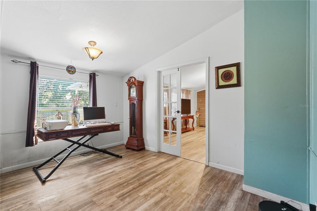 1205 Calvary Road Holiday, FL 34691 - Photo 14 of 34 a living room with furniture a wooden floor and a large window