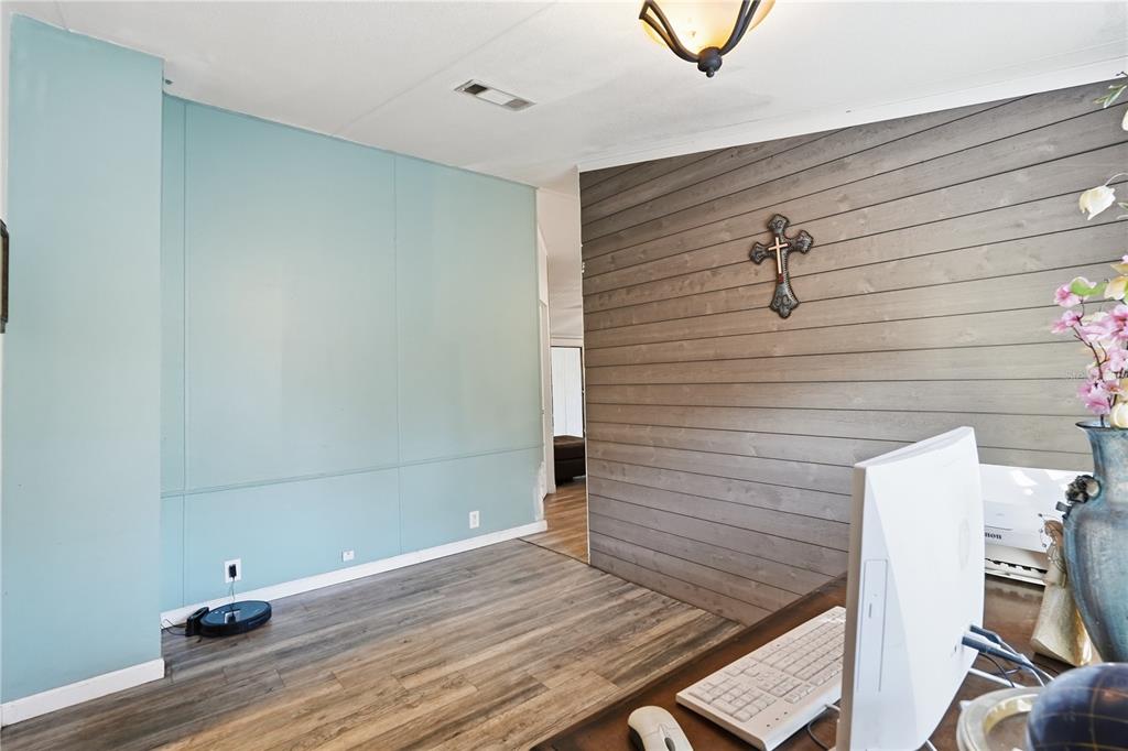 1205 Calvary Road Holiday, FL 34691 - Photo 15 of 34 a view of a room with wooden floor and white walls