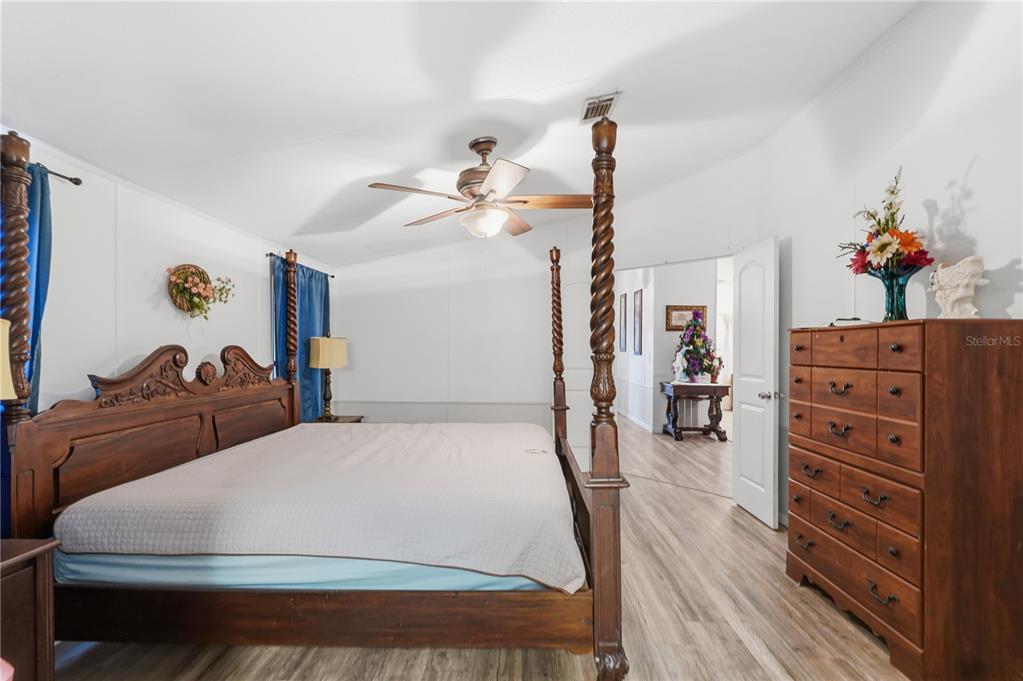 1205 Calvary Road Holiday, FL 34691 - Photo 17 of 34 a bedroom with a bed and wooden floor