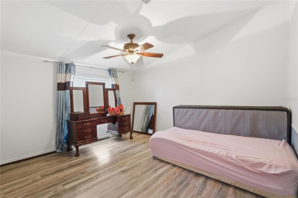 1205 Calvary Road Holiday, FL 34691 - Photo 20 of 34 a bed room with a bed and a chandelier