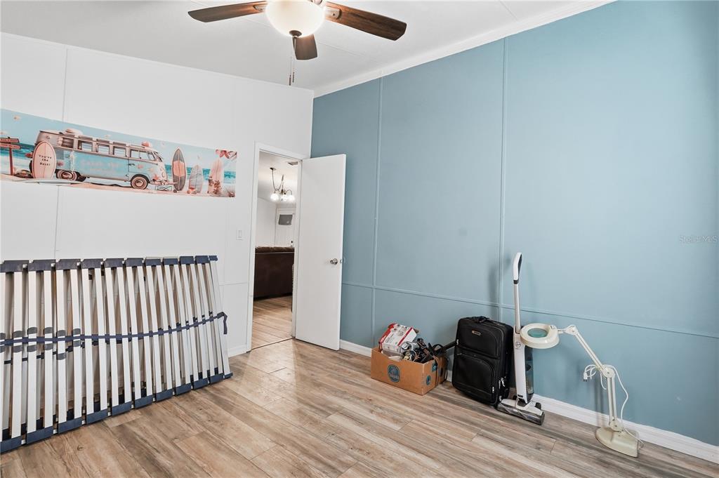 1205 Calvary Road Holiday, FL 34691 - Photo 23 of 34 a bedroom with furniture and a wooden floor
