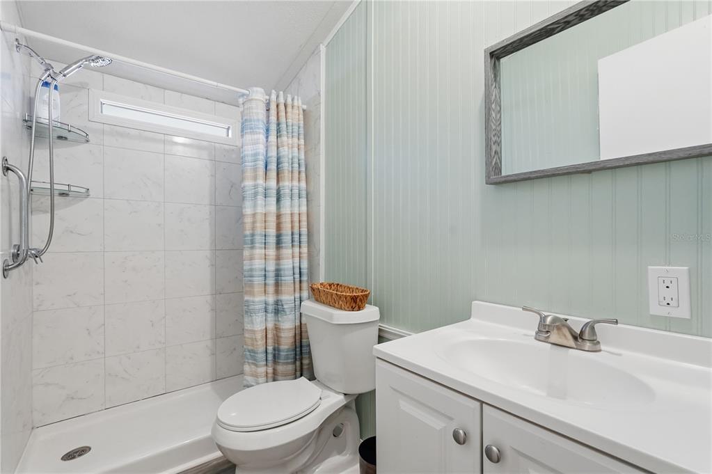 1205 Calvary Road Holiday, FL 34691 - Photo 24 of 34 a bathroom with a sink a toilet and shower