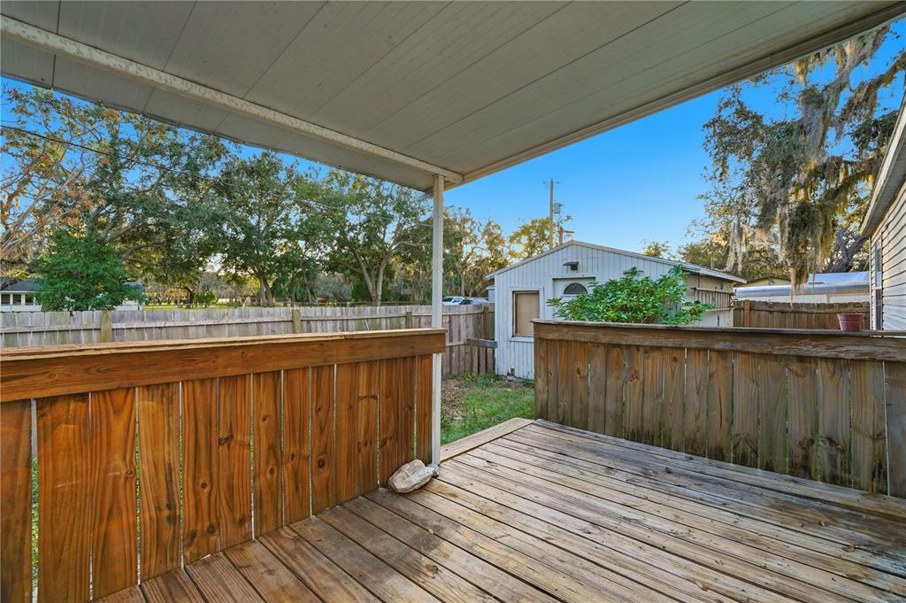 1205 Calvary Road Holiday, FL 34691 - Photo 27 of 34 a balcony with wooden floor and outdoor space