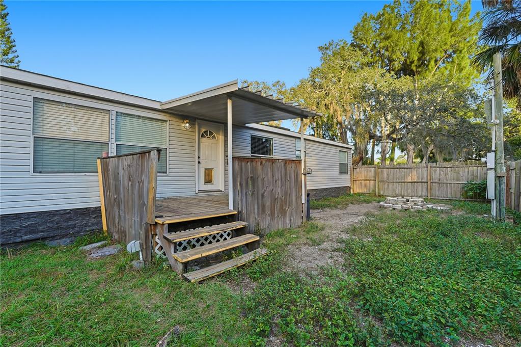 1205 Calvary Road Holiday, FL 34691 - Photo 28 of 34 a view of a backyard with wooden fence and a bench