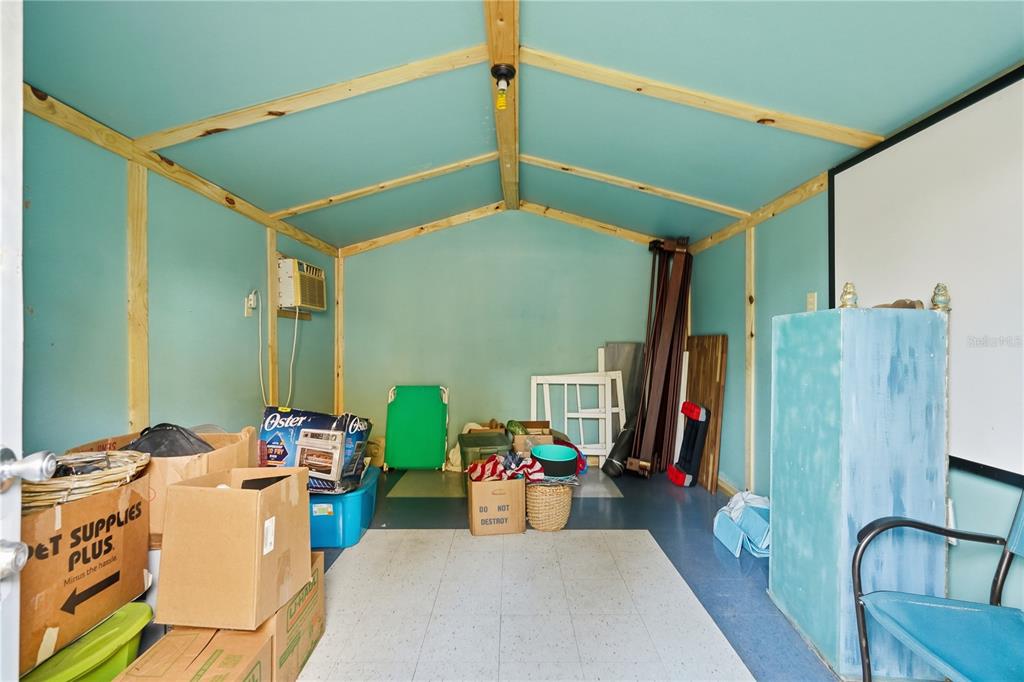 1205 Calvary Road Holiday, FL 34691 - Photo 31 of 34 a bed room with furniture and a flat screen tv