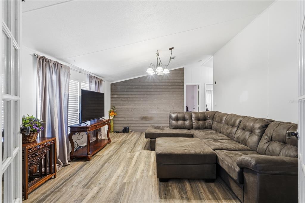 1205 Calvary Road Holiday, FL 34691 - Photo 4 of 34 a living room with furniture and a flat screen tv