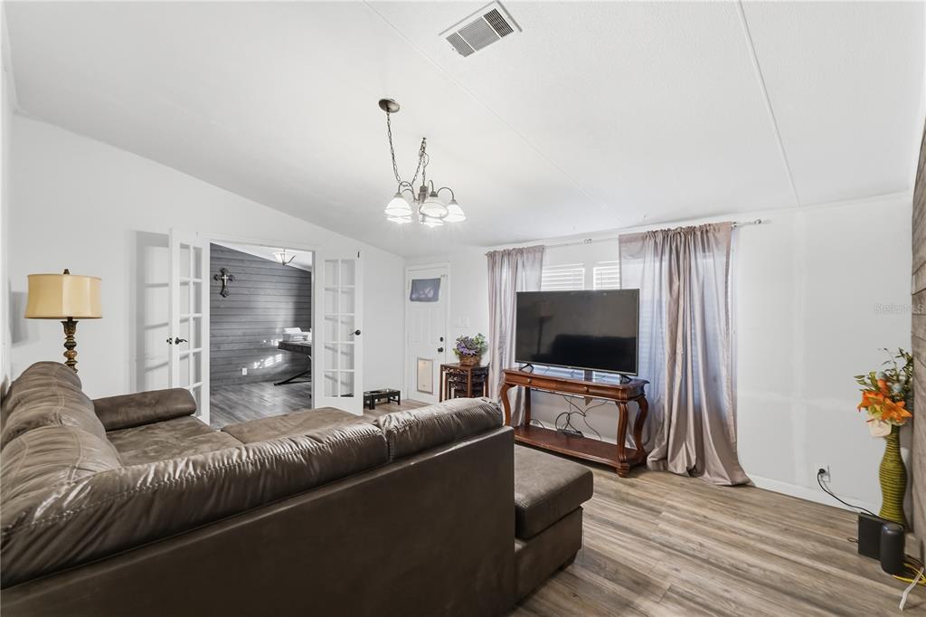 1205 Calvary Road Holiday, FL 34691 - Photo 5 of 34 a living room with furniture and a flat screen tv