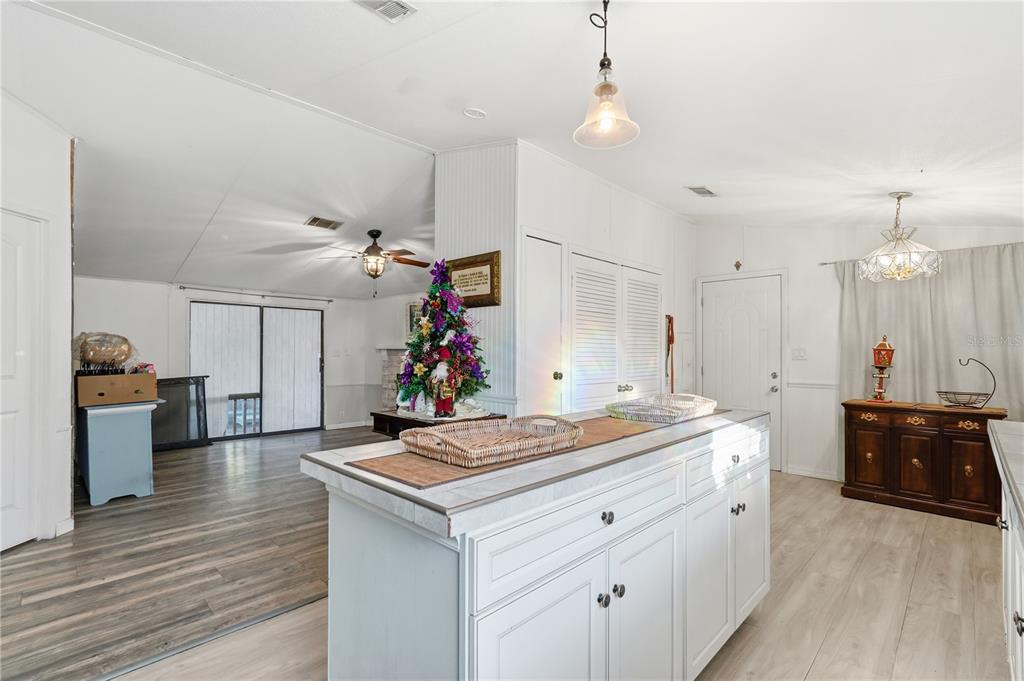 1205 Calvary Road Holiday, FL 34691 - Photo 7 of 34 a room with kitchen island a sink and a stove