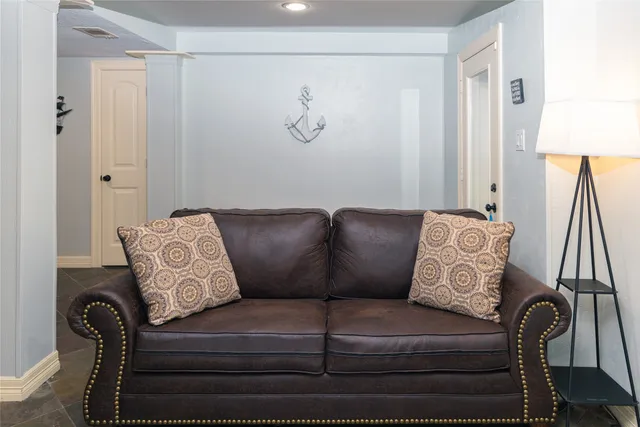 a dining room with furniture wooden floor a chandelier and a mirror