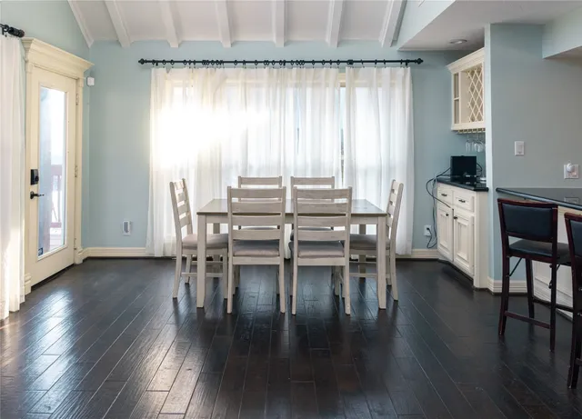 a view of a hallway with wooden floor and closet