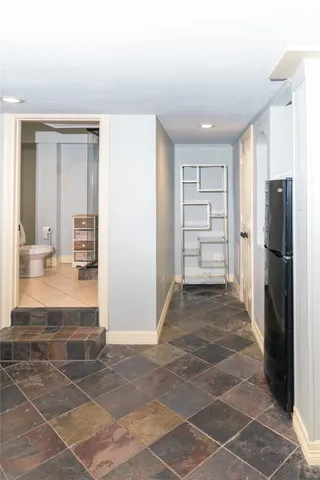 a living room with furniture flowerpot and wooden floor