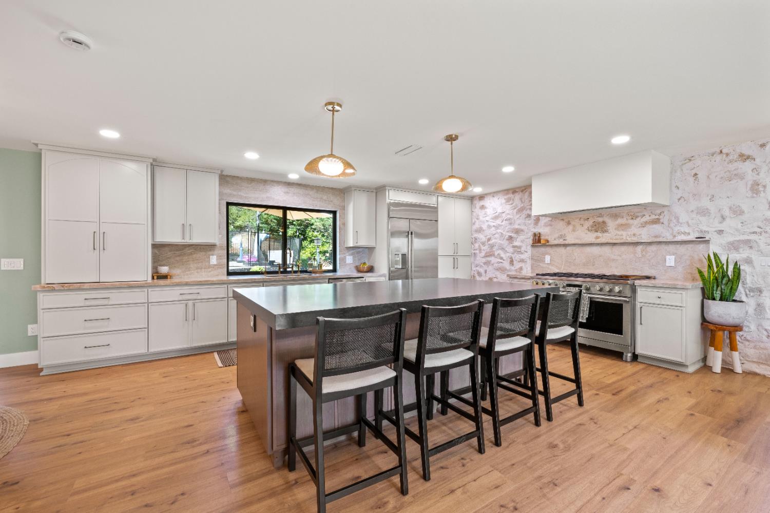 7945 Callison Road Penryn, CA 95663 - Photo 16 of 70 a kitchen with stainless steel appliances kitchen island granite countertop a table chairs and wooden floor