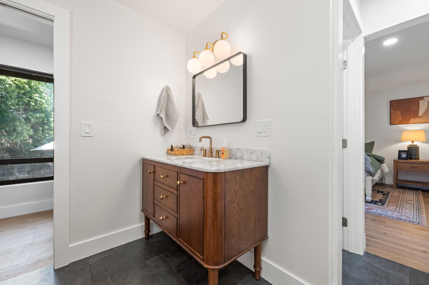 7945 Callison Road Penryn, CA 95663 - Photo 28 of 70 a en suite bathroom with a double vanity sink and a mirror