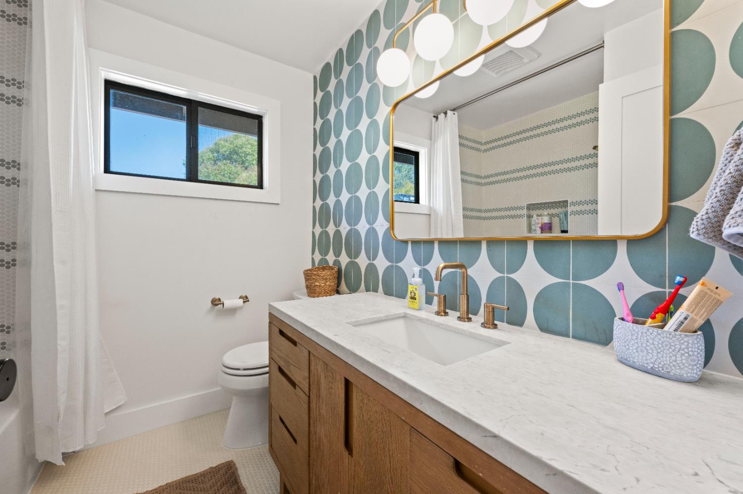 7945 Callison Road Penryn, CA 95663 - Photo 32 of 70 a bathroom with a granite countertop sink and a mirror