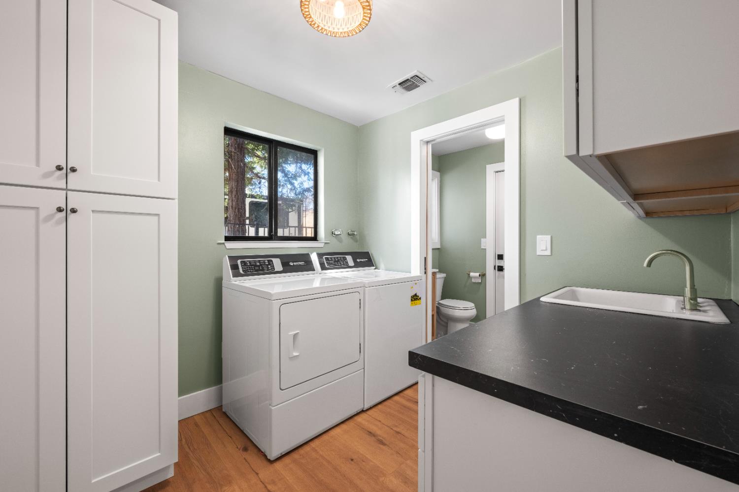 7945 Callison Road Penryn, CA 95663 - Photo 34 of 70 a view of a kitchen from a sink and dishwasher with wooden floor