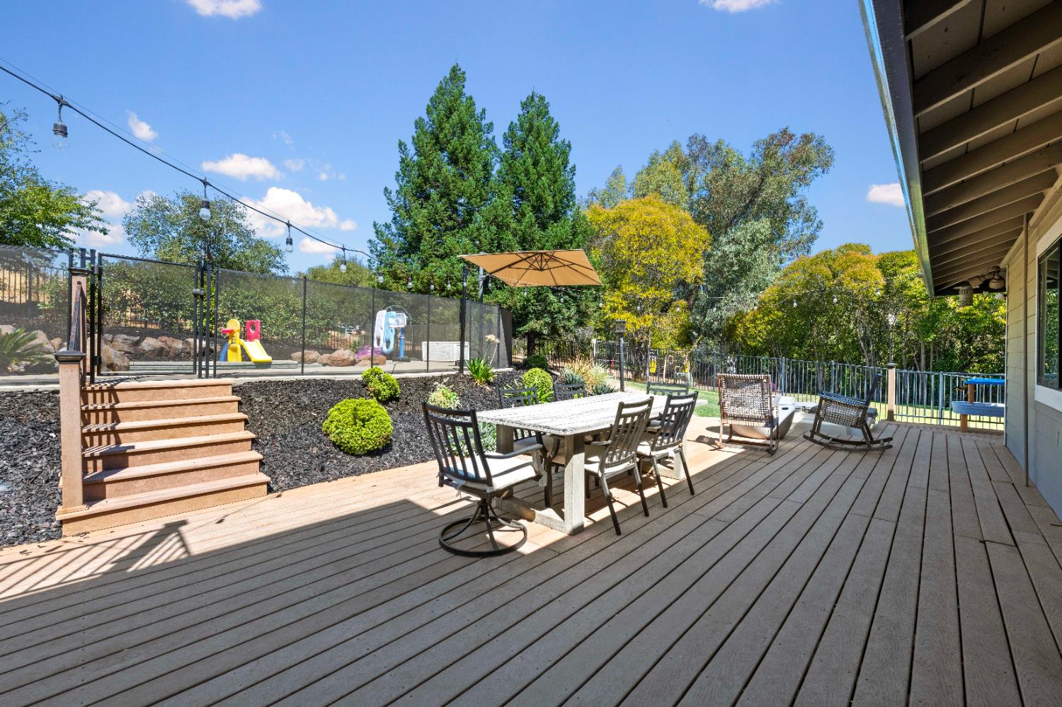 7945 Callison Road Penryn, CA 95663 - Photo 45 of 70 a view of a patio with table and chairs and potted plants with wooden floor
