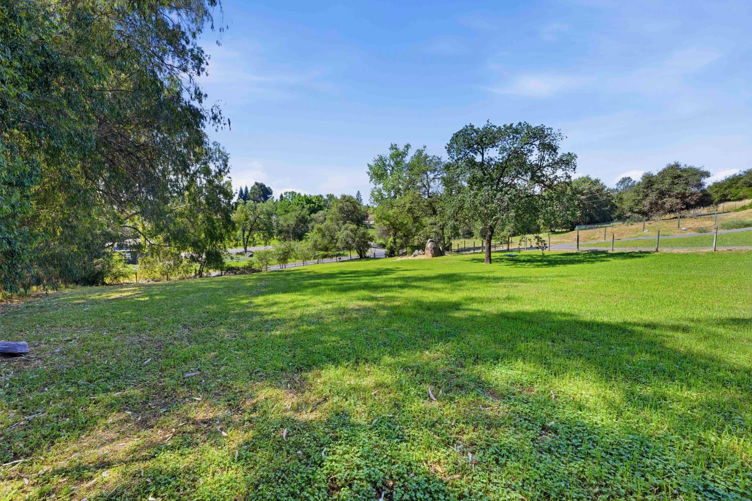 7945 Callison Road Penryn, CA 95663 - Photo 60 of 70 a backyard of a house with lots of green space and outdoor seating