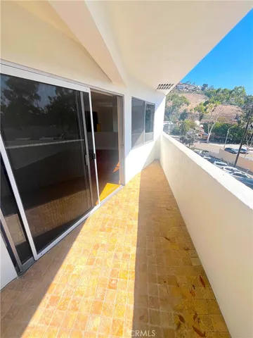 a living room with stainless steel appliances kitchen island granite countertop a sink and cabinets