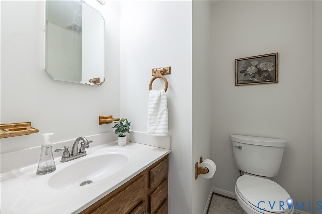 247 Tranquility Drive Ruther Glen, VA 22546 - Photo 20 of 50 a bathroom with a toilet sink and mirror