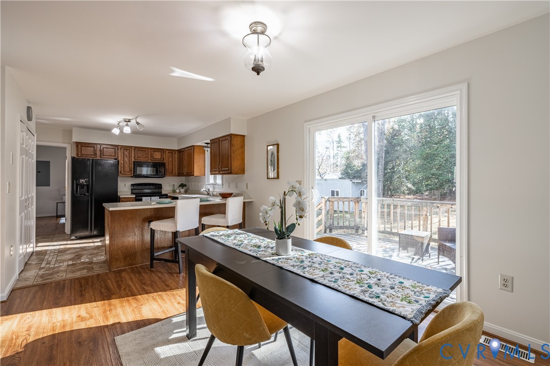 247 Tranquility Drive Ruther Glen, VA 22546 - Photo 22 of 50 a living room with kitchen island furniture and a wooden floor