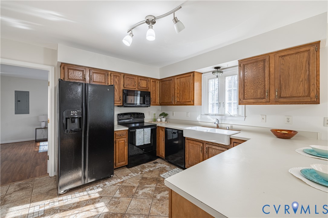 247 Tranquility Drive Ruther Glen, VA 22546 - Photo 24 of 50 a kitchen with stainless steel appliances granite countertop a refrigerator a sink dishwasher a stove with wooden cabinets and floor