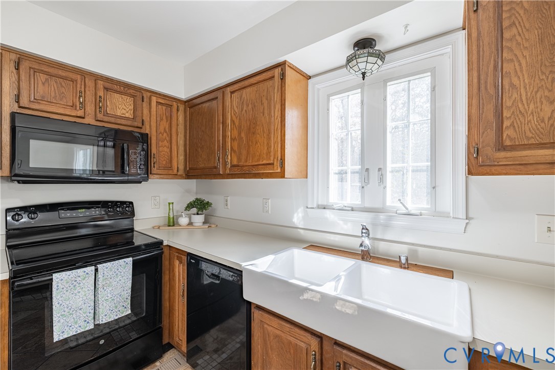 247 Tranquility Drive Ruther Glen, VA 22546 - Photo 25 of 50 a kitchen with stainless steel appliances a stove sink microwave and cabinets