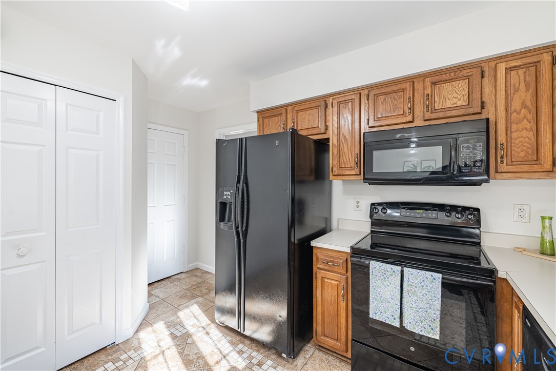 247 Tranquility Drive Ruther Glen, VA 22546 - Photo 26 of 50 a kitchen with granite countertop a refrigerator stove and microwave