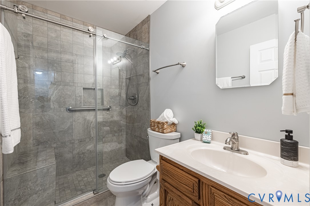247 Tranquility Drive Ruther Glen, VA 22546 - Photo 35 of 50 a bathroom with a sink toilet and shower
