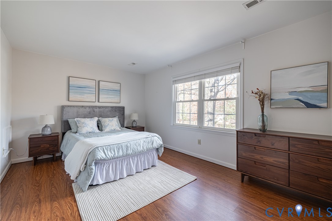 247 Tranquility Drive Ruther Glen, VA 22546 - Photo 36 of 50 a spacious bedroom with a bed and wooden floor