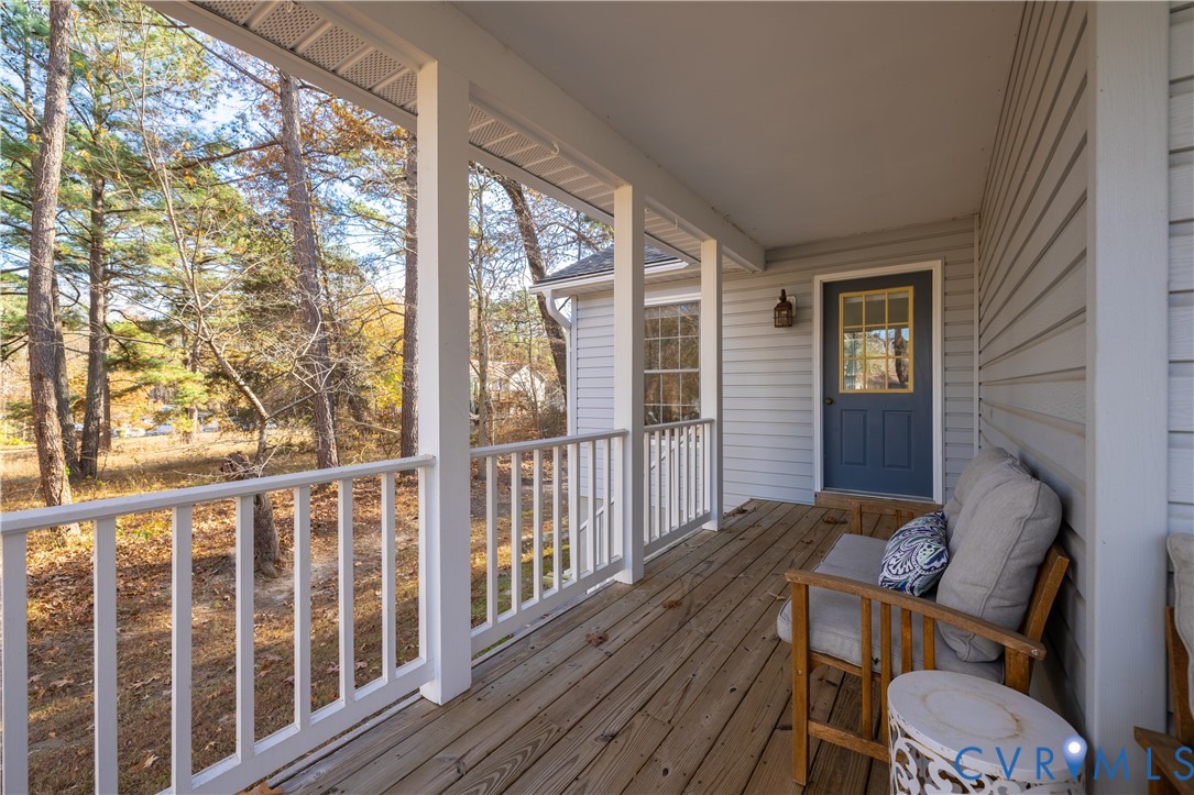 247 Tranquility Drive Ruther Glen, VA 22546 - Photo 7 of 50 a view of balcony with wooden floor and furniture