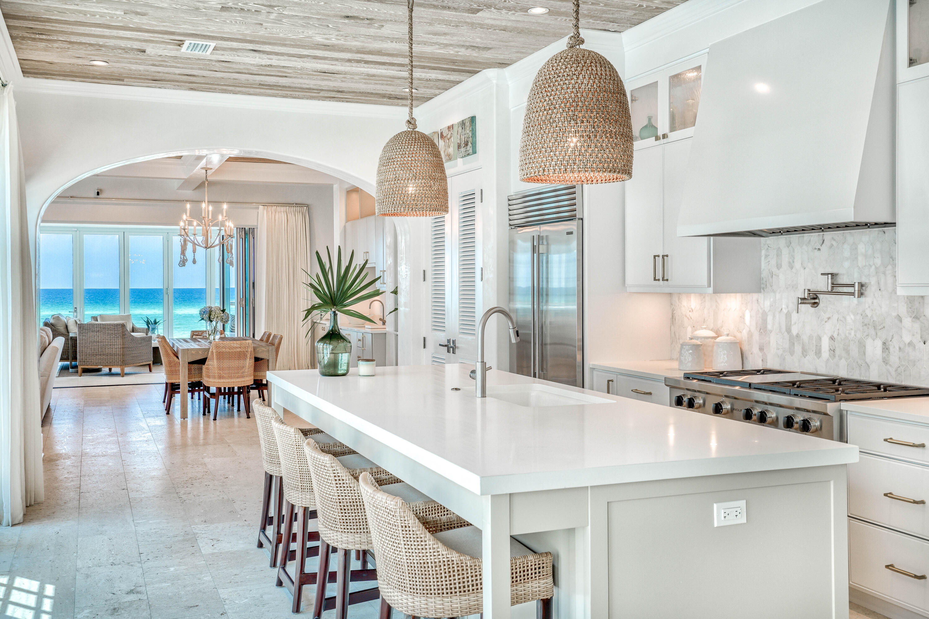 153 Pelican Cir Inlet Beach, Unit A Inlet Beach, FL 32461 - Photo 23 of 94 a kitchen with stainless steel appliances granite countertop a stove a refrigerator a dining table and chairs with wooden floor