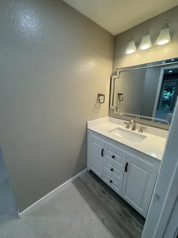 a bathroom with a double vanity sink and a mirror