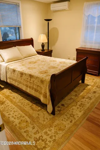 a bedroom with a bed and a night stand