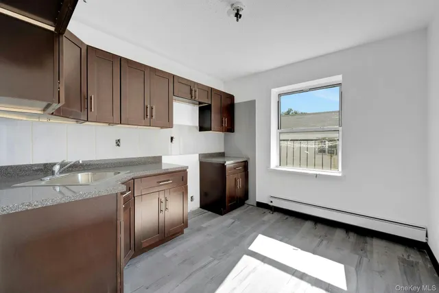 a kitchen with a refrigerator and a stove top oven