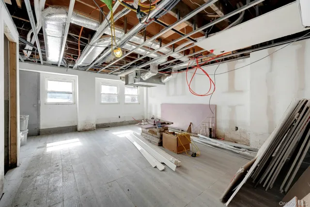 a view of a patio with table and chairs with wooden floor and fence