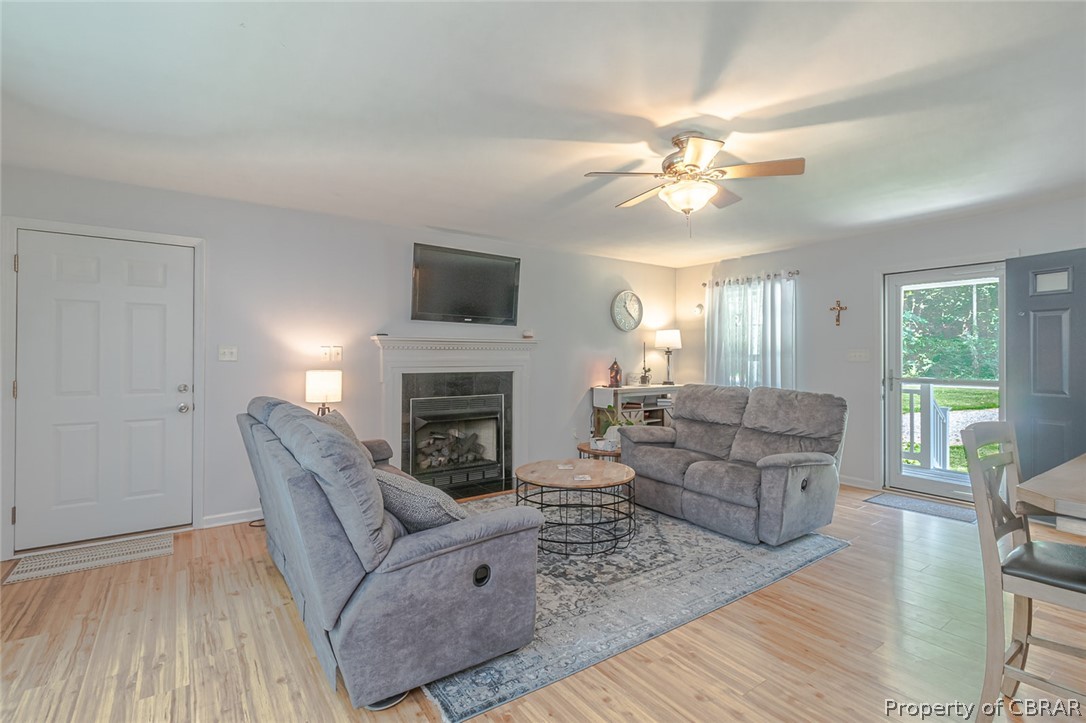 11654 Courthouse Road Lancaster, VA 22503 - Photo 5 of 35 a living room with furniture a fireplace and a flat screen tv
