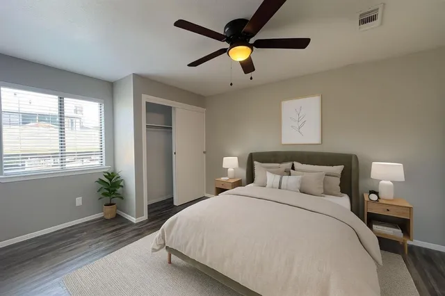 a bedroom with a bed and a large window