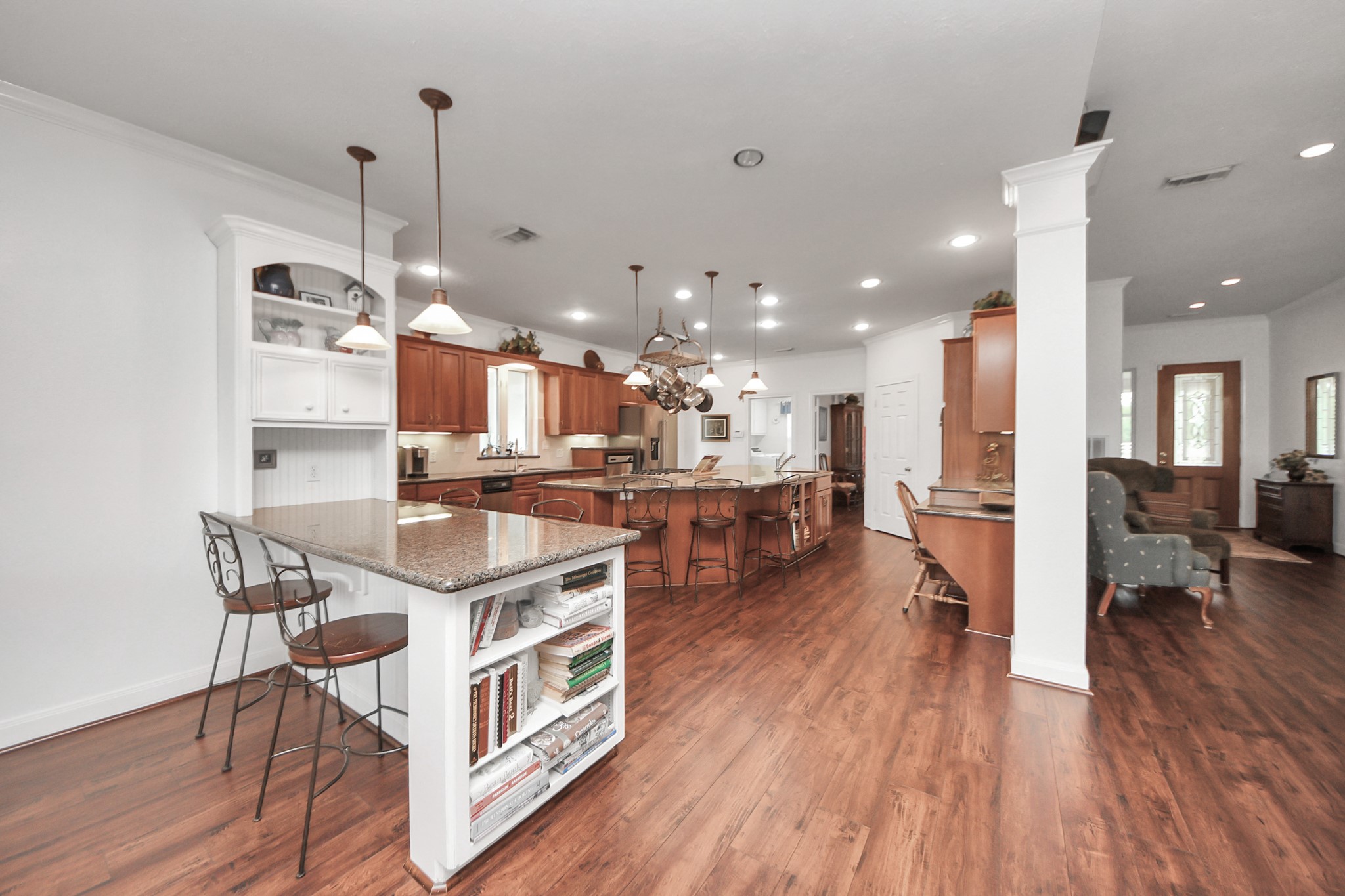 7511 County Road 511 Rosharon, TX 77583 - Photo 14 of 42 a open kitchen with stainless steel appliances granite countertop a stove top oven a refrigerator a sink and a dining table with wooden floor