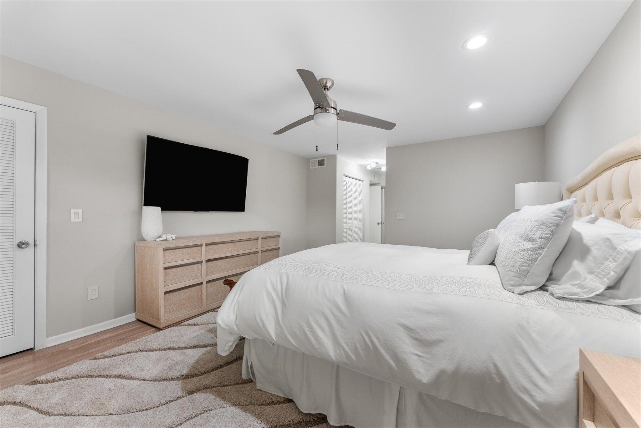 30 Westgate Lane, Unit 30G Boynton Beach, FL 33436 - Photo 12 of 58 a bedroom with a bed and a flat screen tv