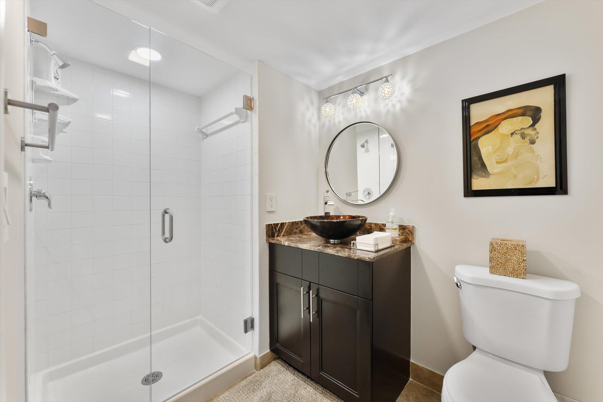 30 Westgate Lane, Unit 30G Boynton Beach, FL 33436 - Photo 20 of 58 a bathroom with a toilet sink vanity granite and shower