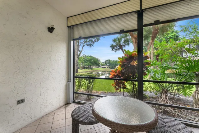 a very nice looking living room with a dining table a rug and kitchen view