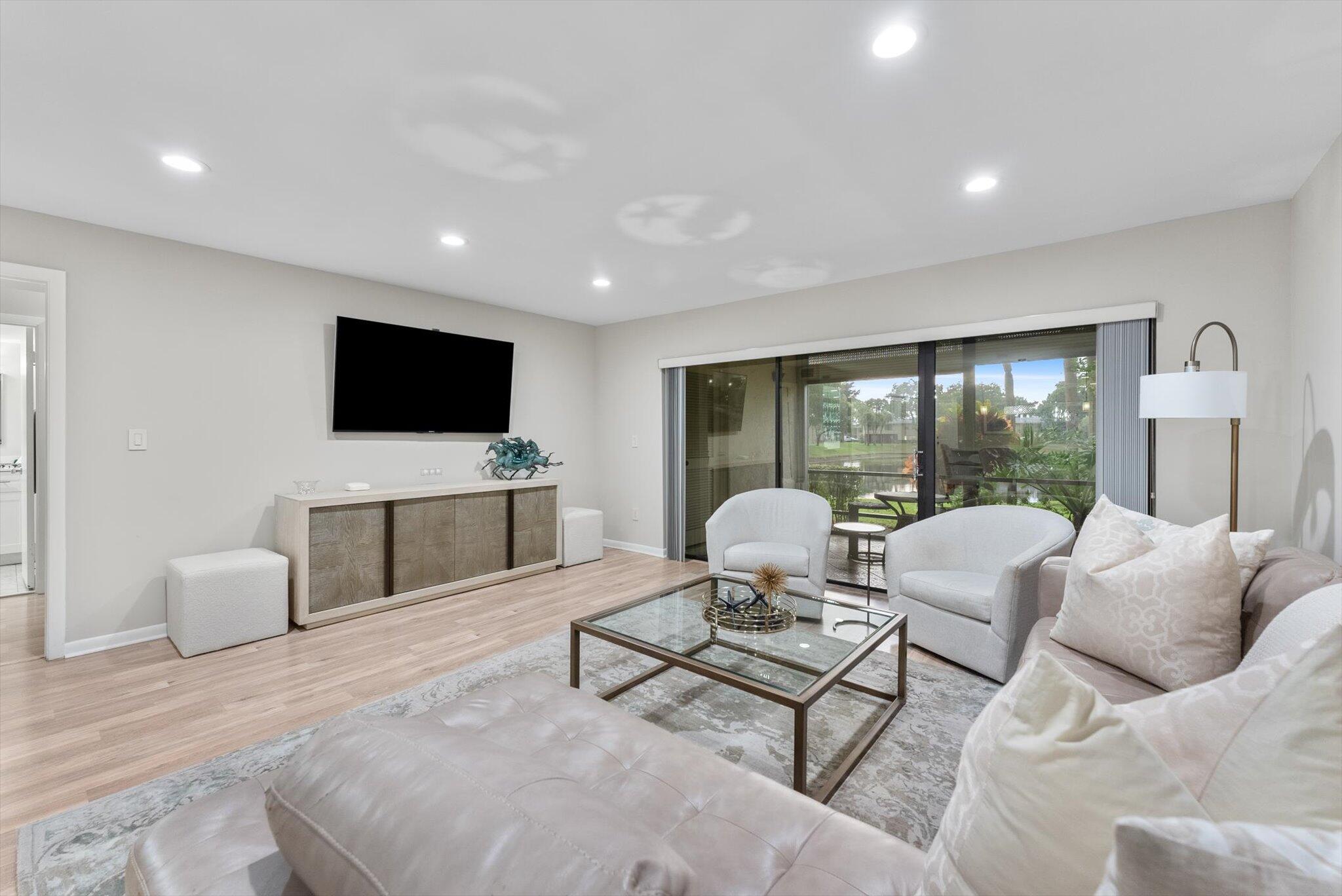 30 Westgate Lane, Unit 30G Boynton Beach, FL 33436 - Photo 7 of 58 a living room with furniture and a flat screen tv