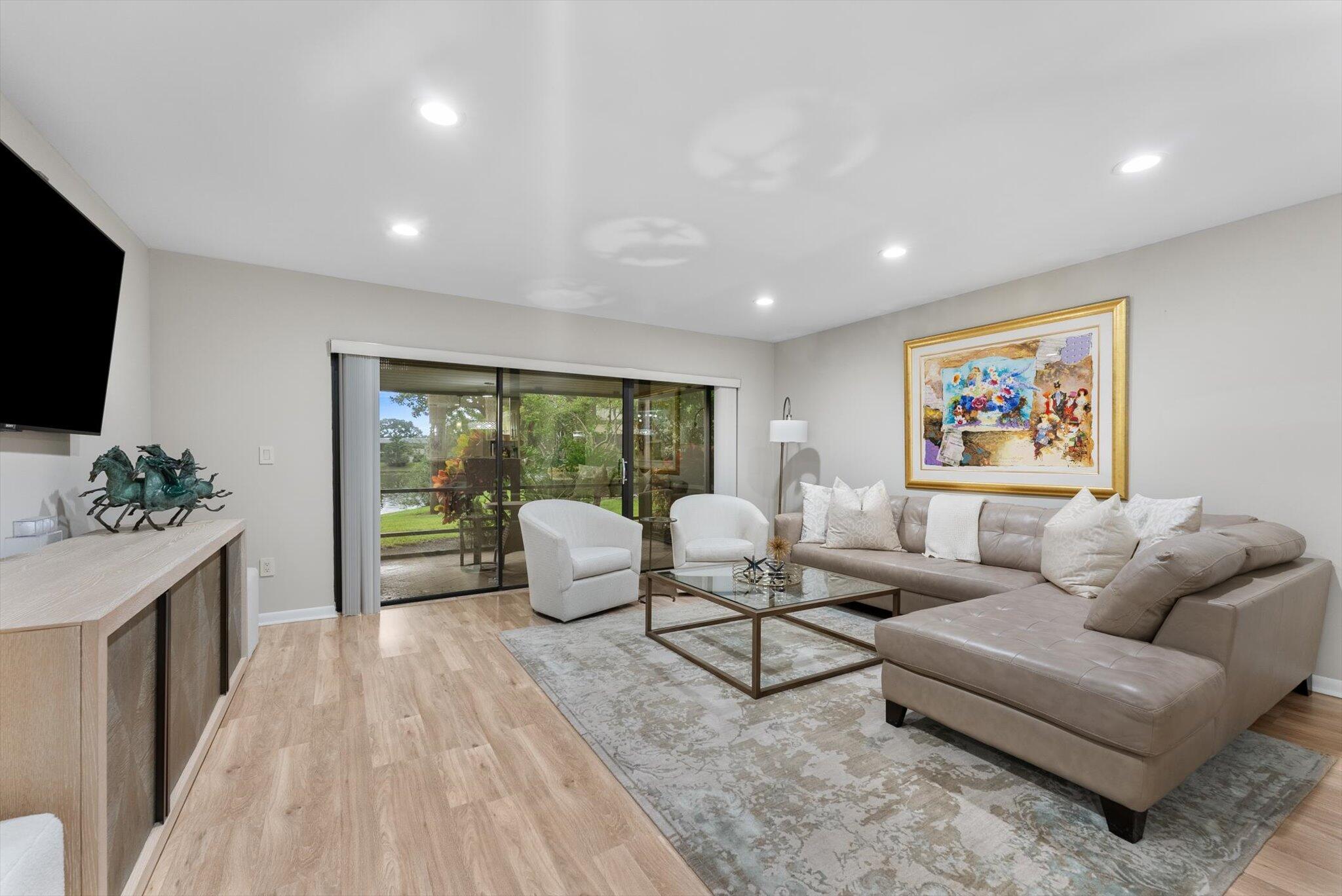 30 Westgate Lane, Unit 30G Boynton Beach, FL 33436 - Photo 8 of 58 a living room with furniture and a flat screen tv