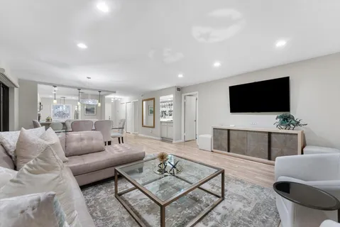 a bathroom with a toilet sink vanity granite and shower
