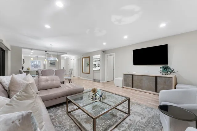 a bathroom with a toilet sink vanity granite and shower