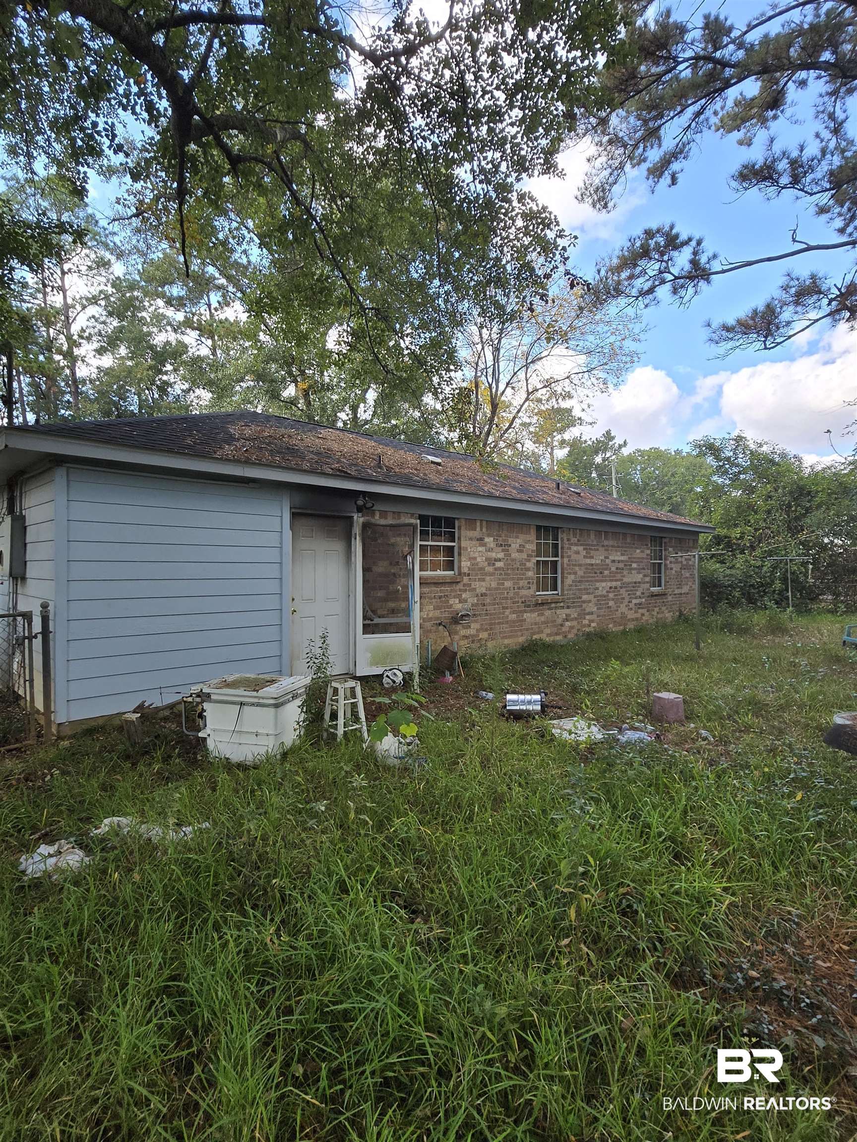 1820 North Cedar Street Foley, AL 36535 - Photo 5 of 14 Rear view of house featuring brick siding and roof with shingles