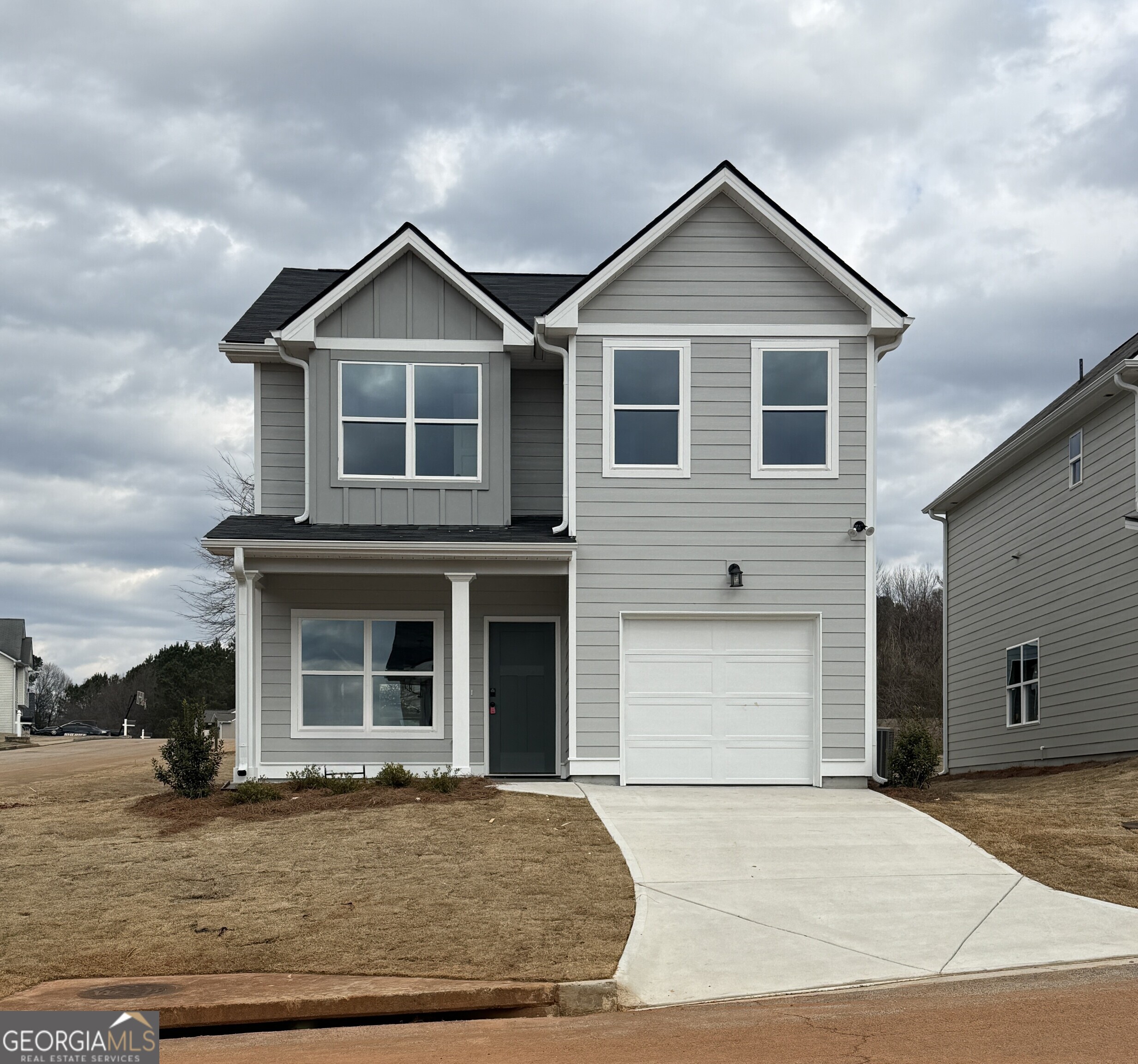 a front view of a house with a yard and garage