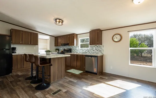 a kitchen with a refrigerator and a stove top oven